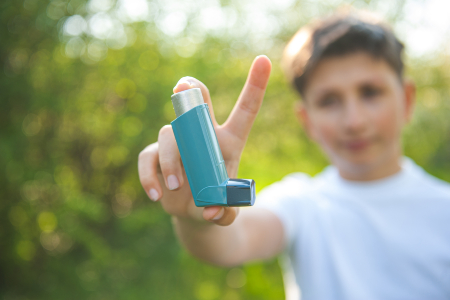 Boy Holding Asthma Inhaler