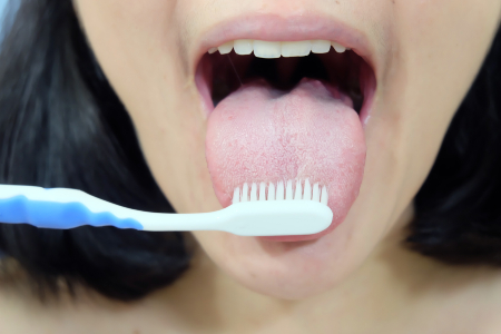 Woman Tongue Brushing