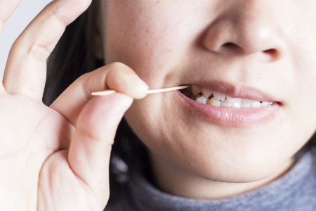 Woman Using a Toothpick