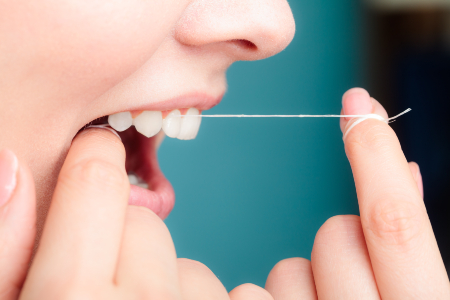 Woman Using Floss