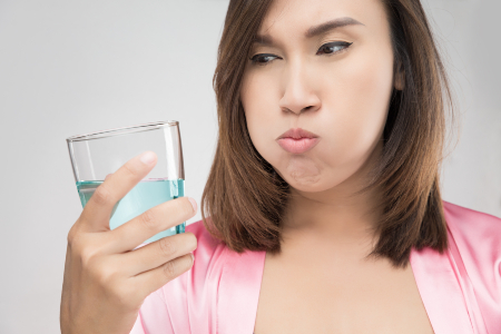 Woman Using Mouthwash